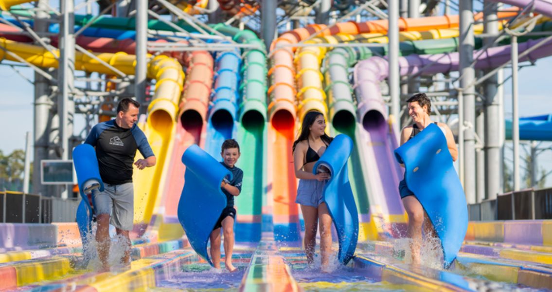 Riders racing down slide